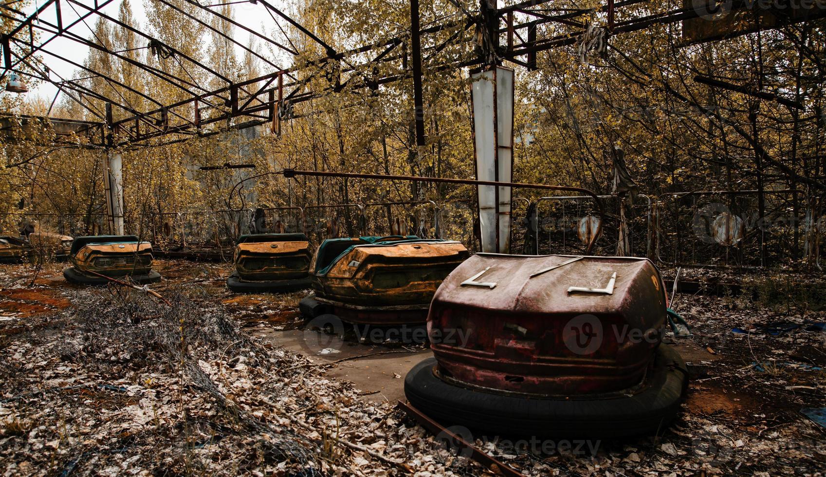 Abandoned amusement park with rusty cars in Pripyat city at Chernobyl exclusion zone. photo