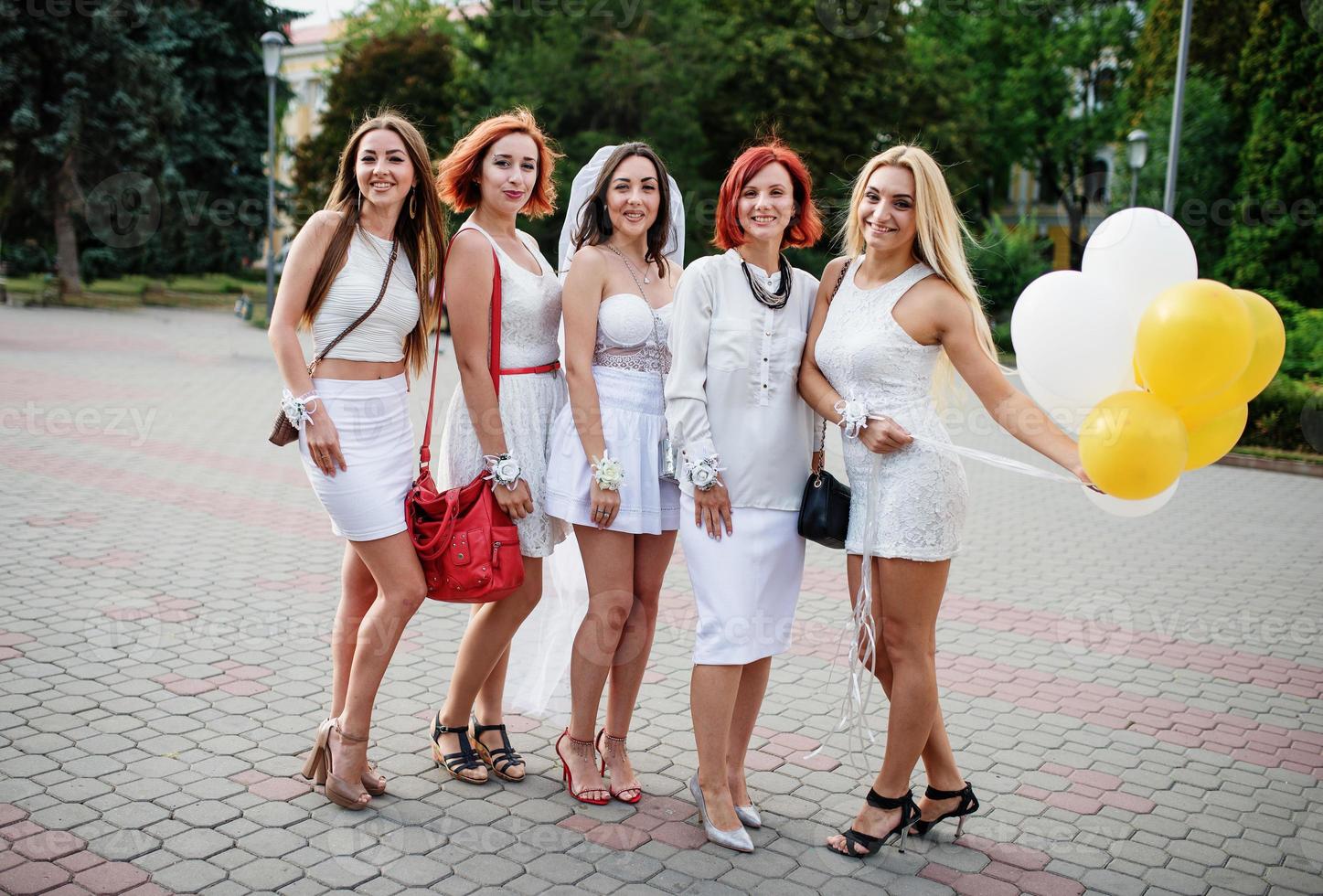 Five girls with balloons at hand on hen party. photo