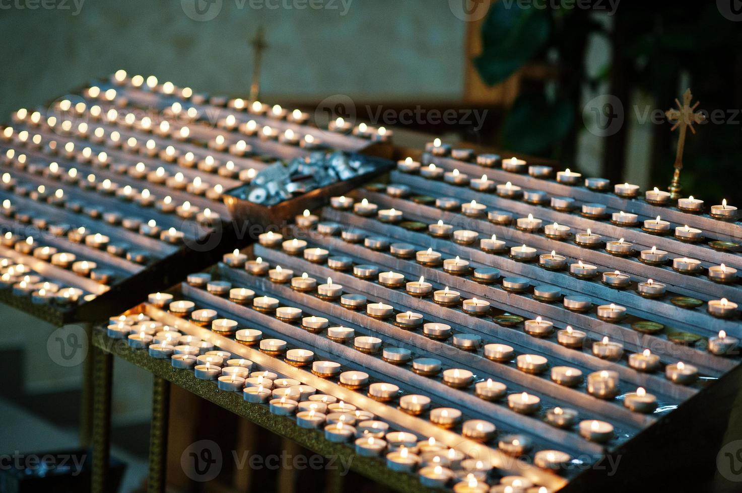 Candles in church. Rows of burning candles in a cathedral photo