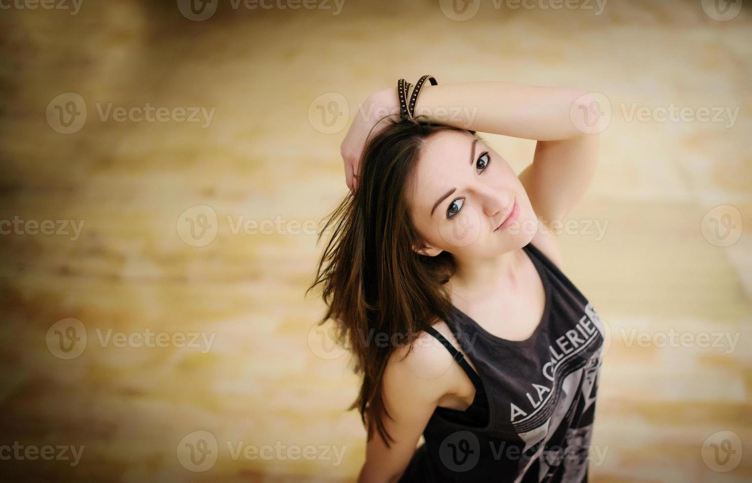 Street dancer girl wearing casual clothes on footless background wooden parquet indoor. photo