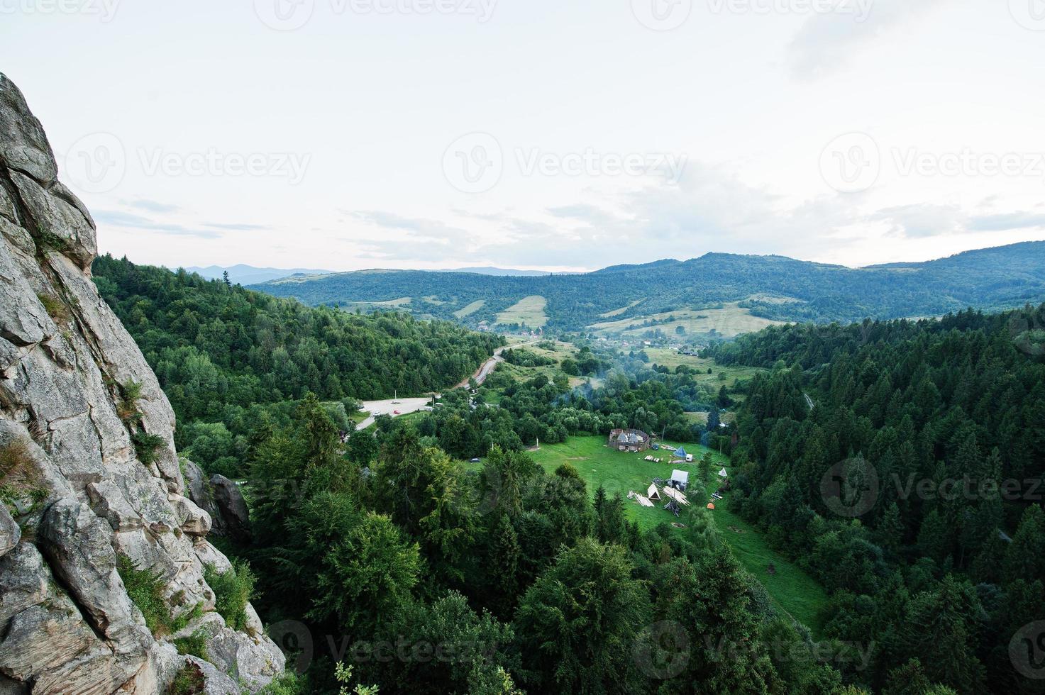 Tustan fortress ruins of rocks at Carpathian Ukraine. View on camping village photo