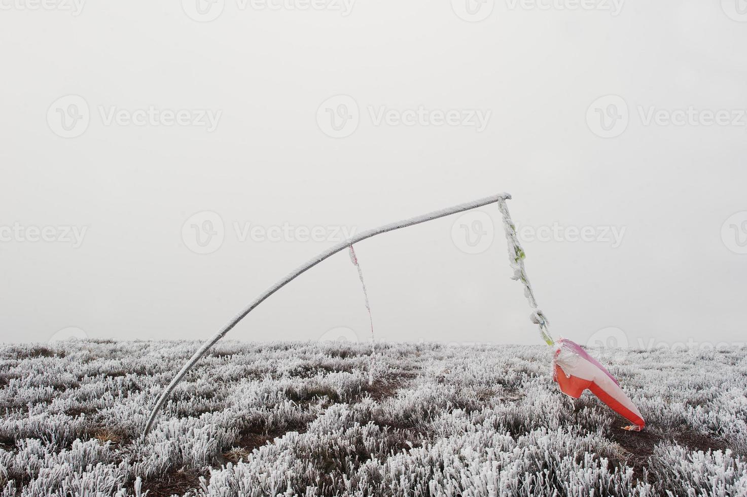 Frozen vane. Indicator of wind direction and flow forces at mountain photo