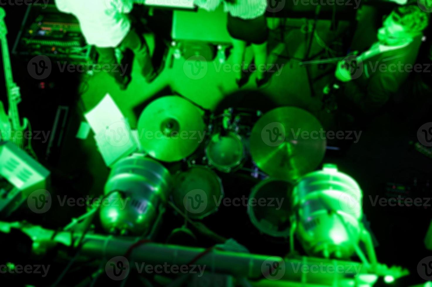 Blured photo of music band on stage, view from above.