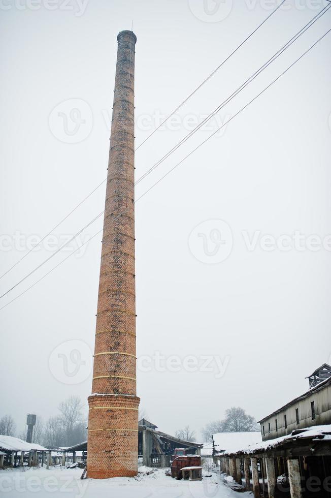 Large brick tower without smoke against foggy sky. photo