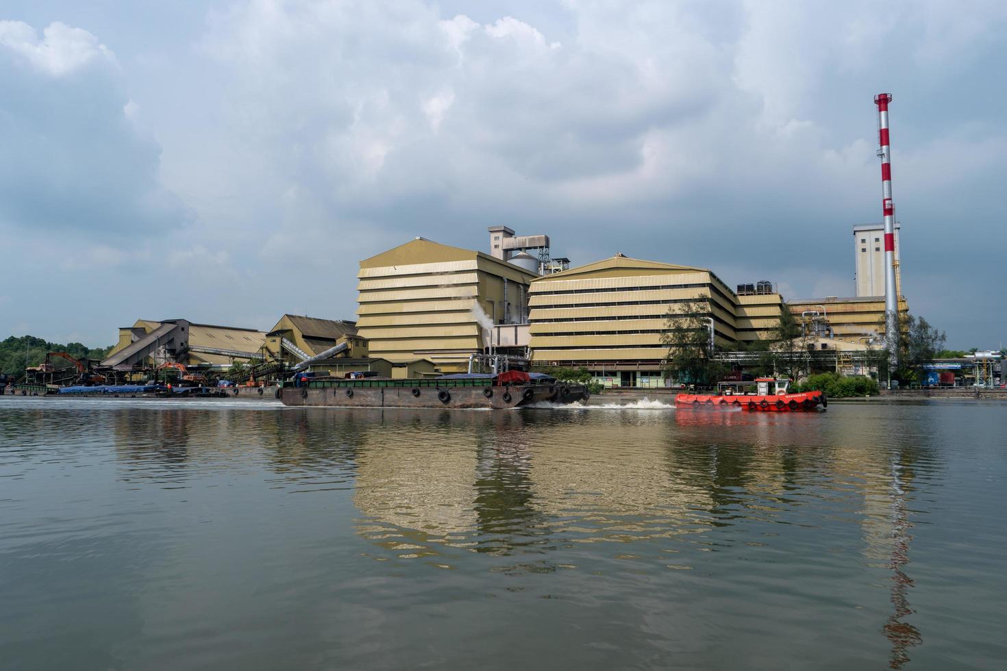 Tug boat pull boat at Prai River. photo