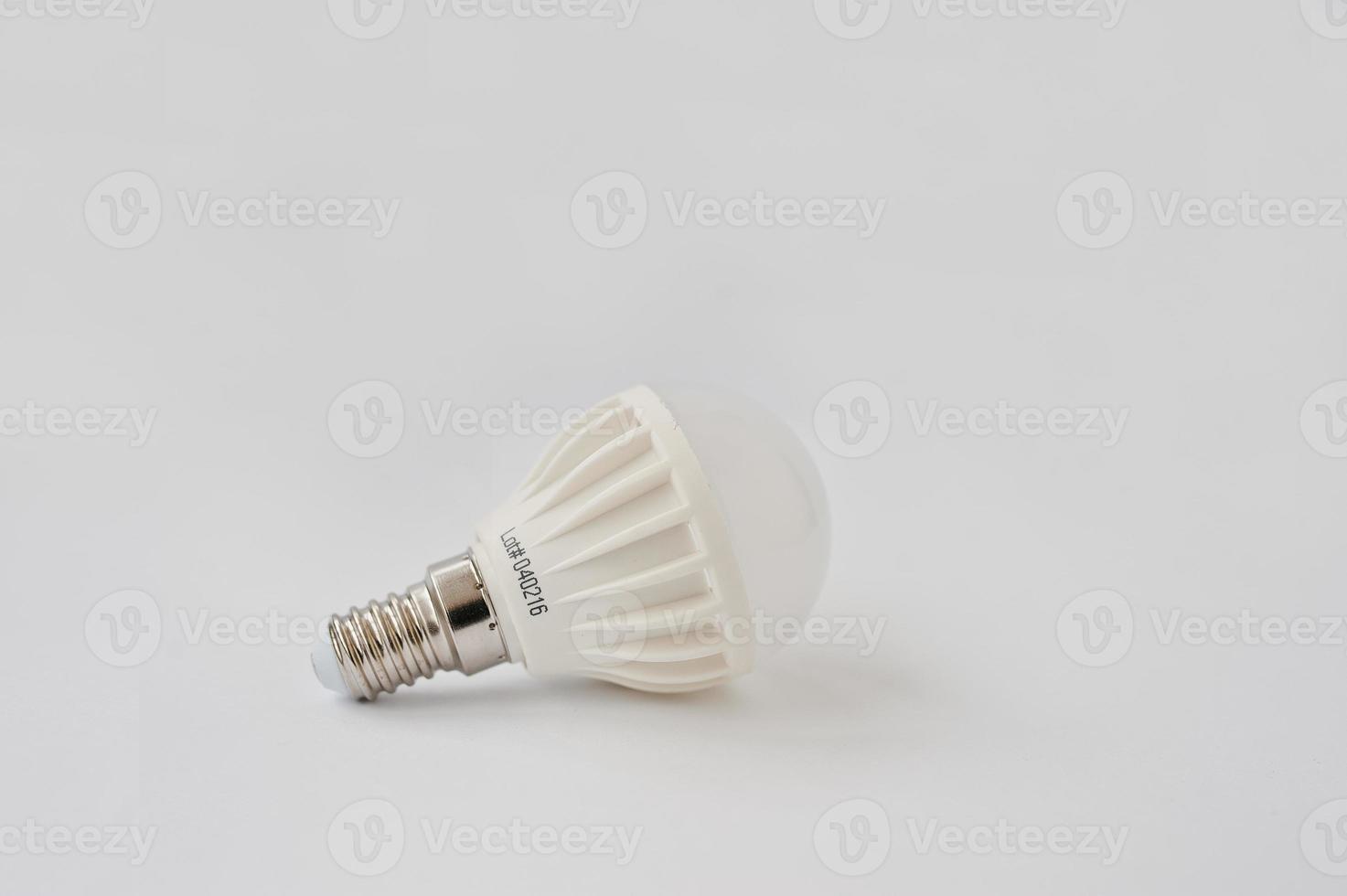 LED bulb 60 V 6 Watt E14 on white background. photo