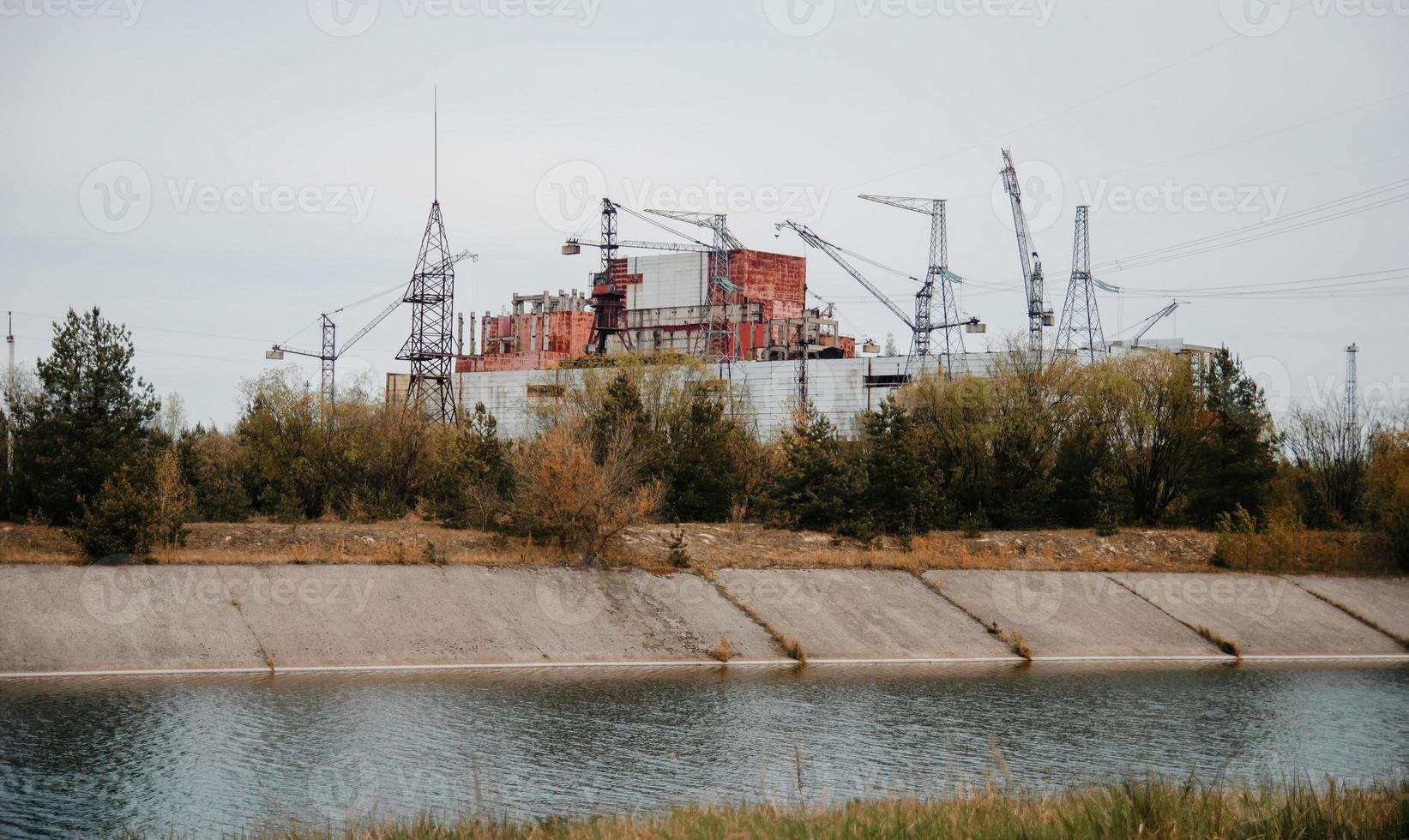 Chernobyl alienation zone. View of Chernobyl atomic plant background river. photo