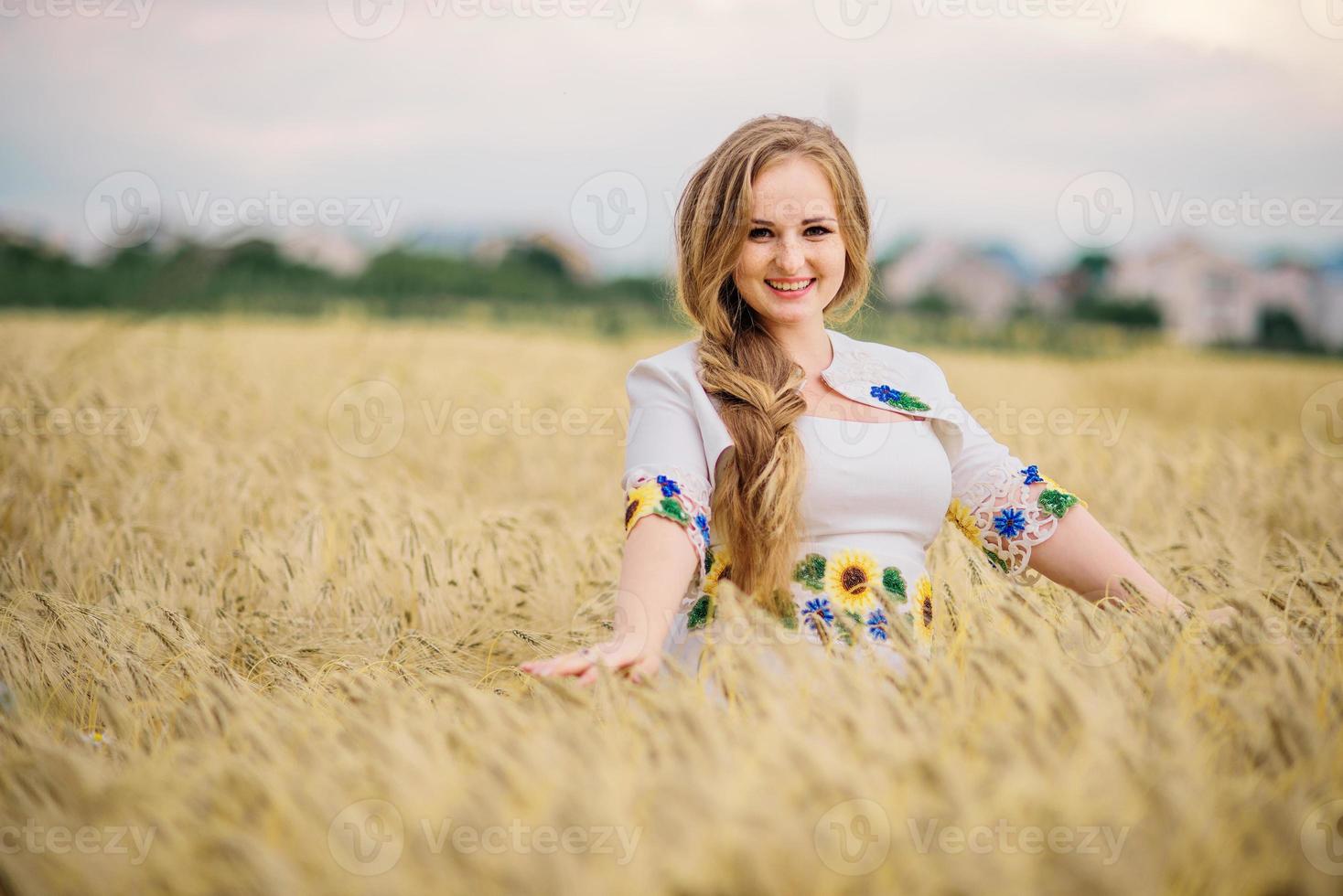 Young girl at ukrainian national dress posed at wreath field. photo