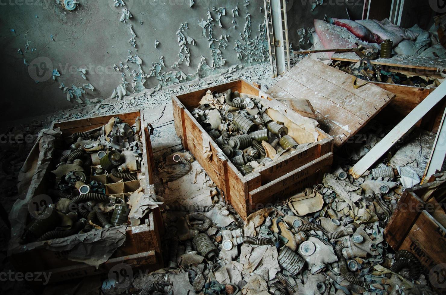 Infected radiation gas masks on the floor at boxes at Chernobyl nuclear power plant zone of alienation. photo