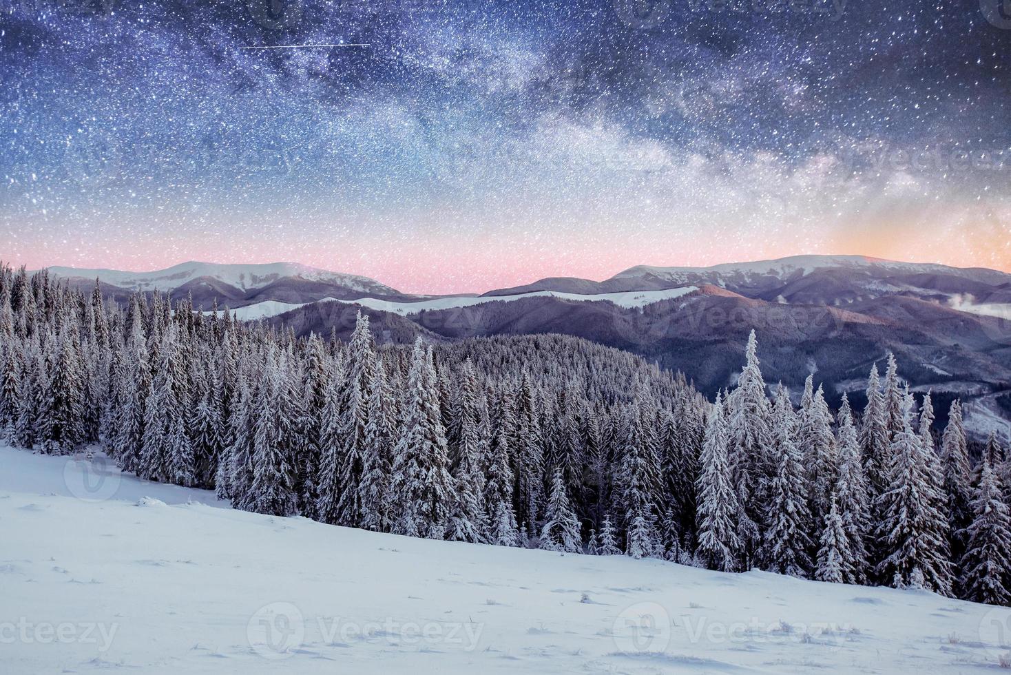 starry sky in winter snowy night. fantastic milky way in the New photo