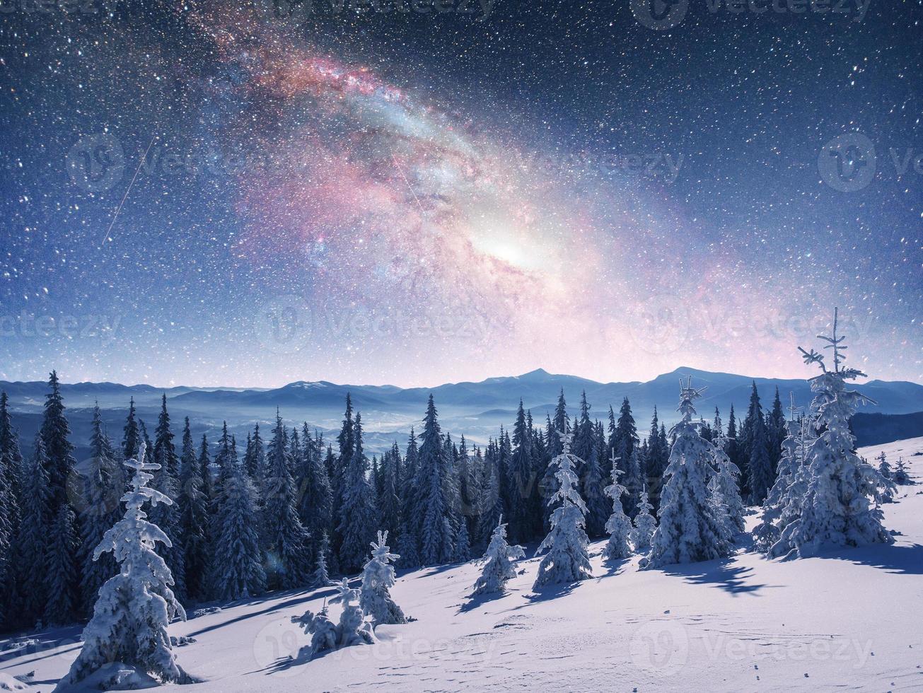 starry sky in winter snowy night. fantastic milky way in the New photo