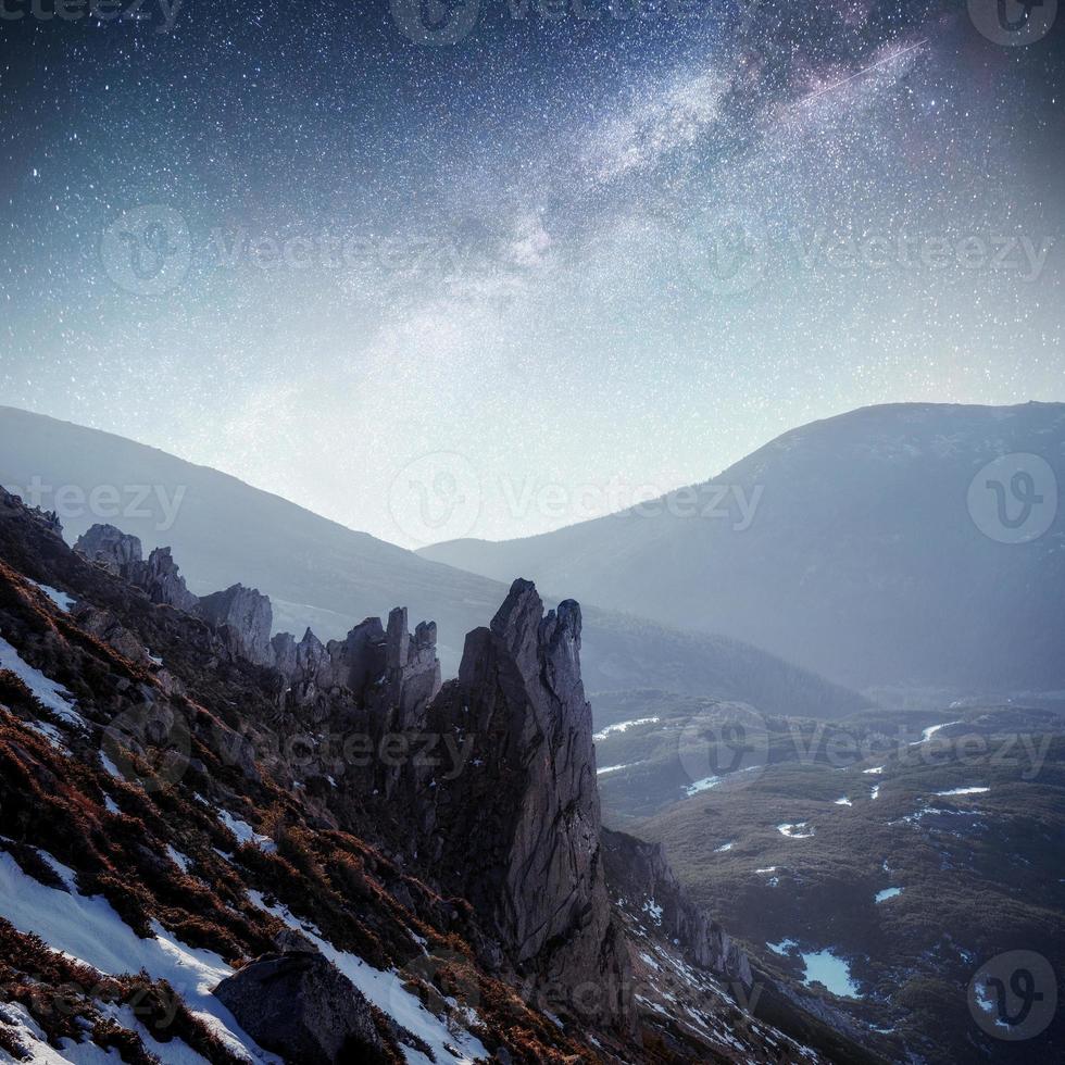 Fantastic starry sky. Autumn landscape and snow-capped peaks. Carpathians, Ukraine Europe photo