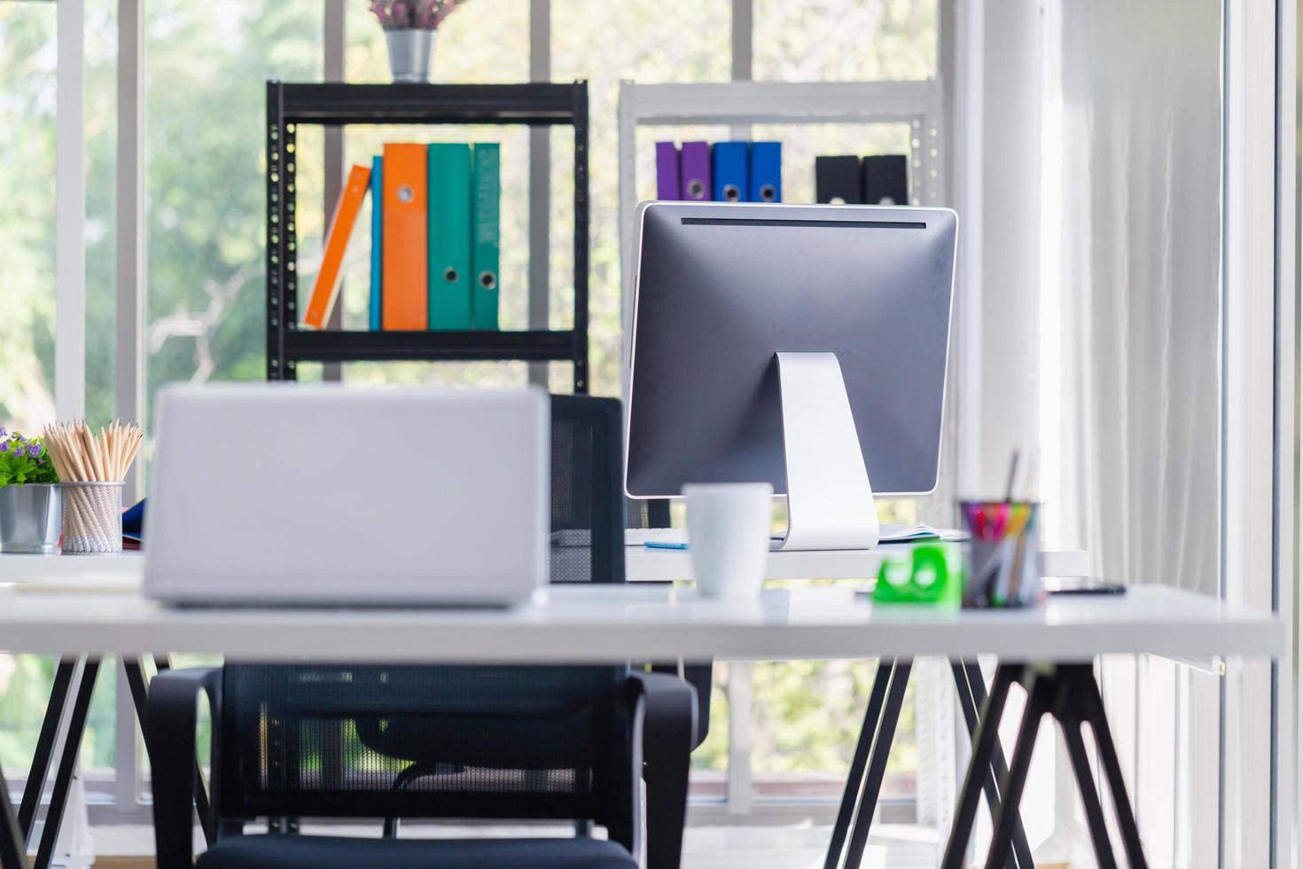 The workplace or work space of table work in modern office with computer and office supplies photo