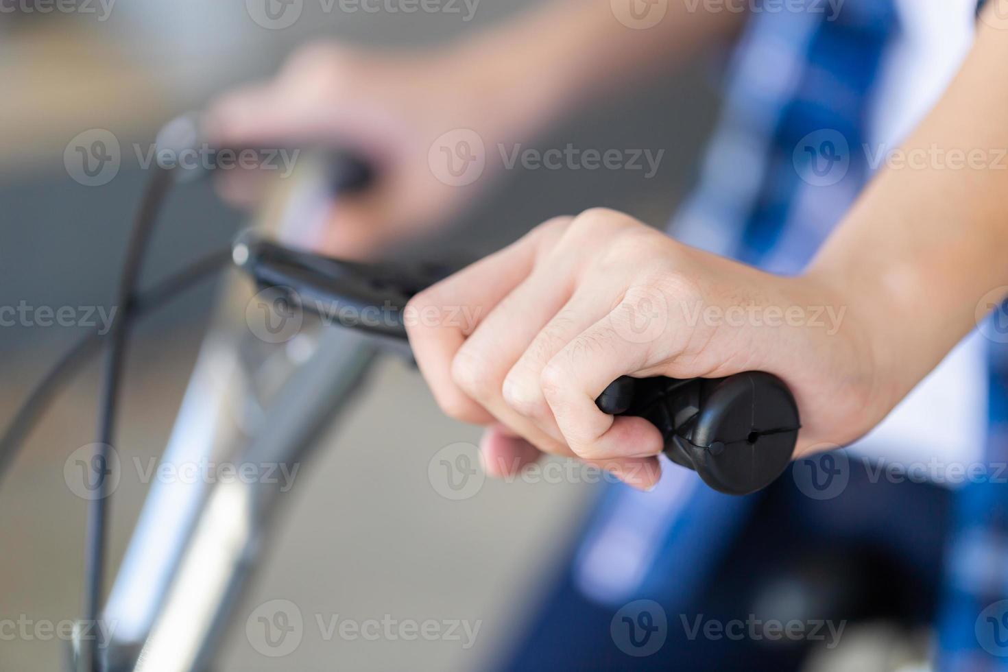 Boy hand holding a bicycle brake. Kid sitting on a bicycle using the handbrake photo