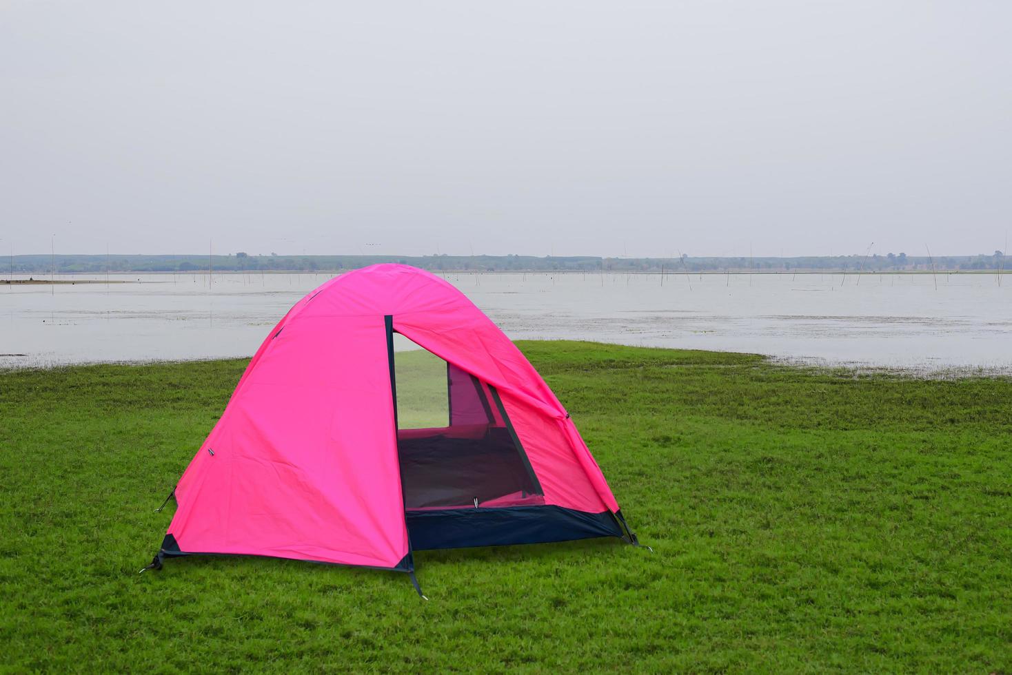 Pink tent in the middle of fields and lakes photo