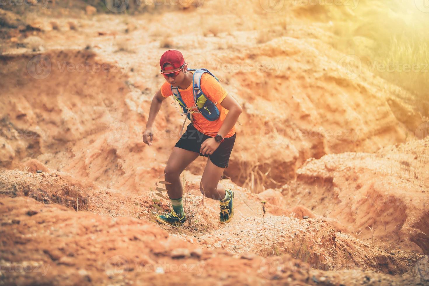 A man Runner of Trail and athlete's feet wearing sports shoes for trail running in the mountain photo