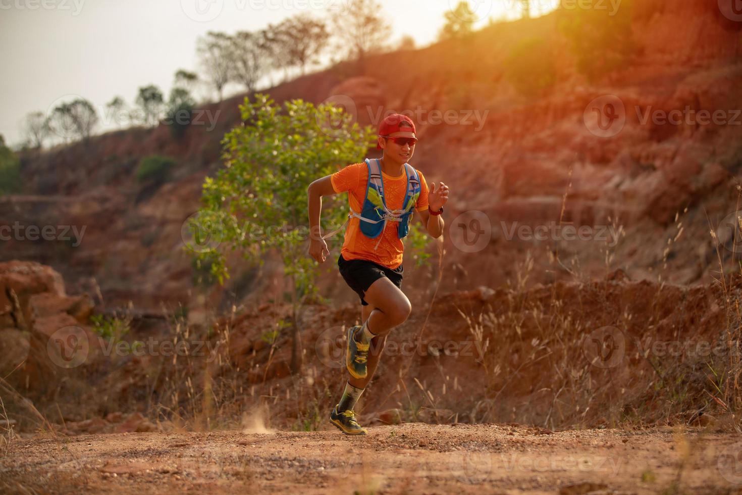 A man Runner of Trail and athlete's feet wearing sports shoes for trail running in the mountain photo