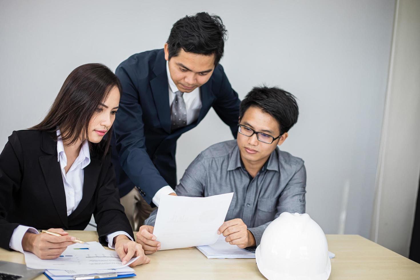 Asian businessmen and group using notebook for business partners discussing documents and ideas at meeting and business women smiling happy for working photo