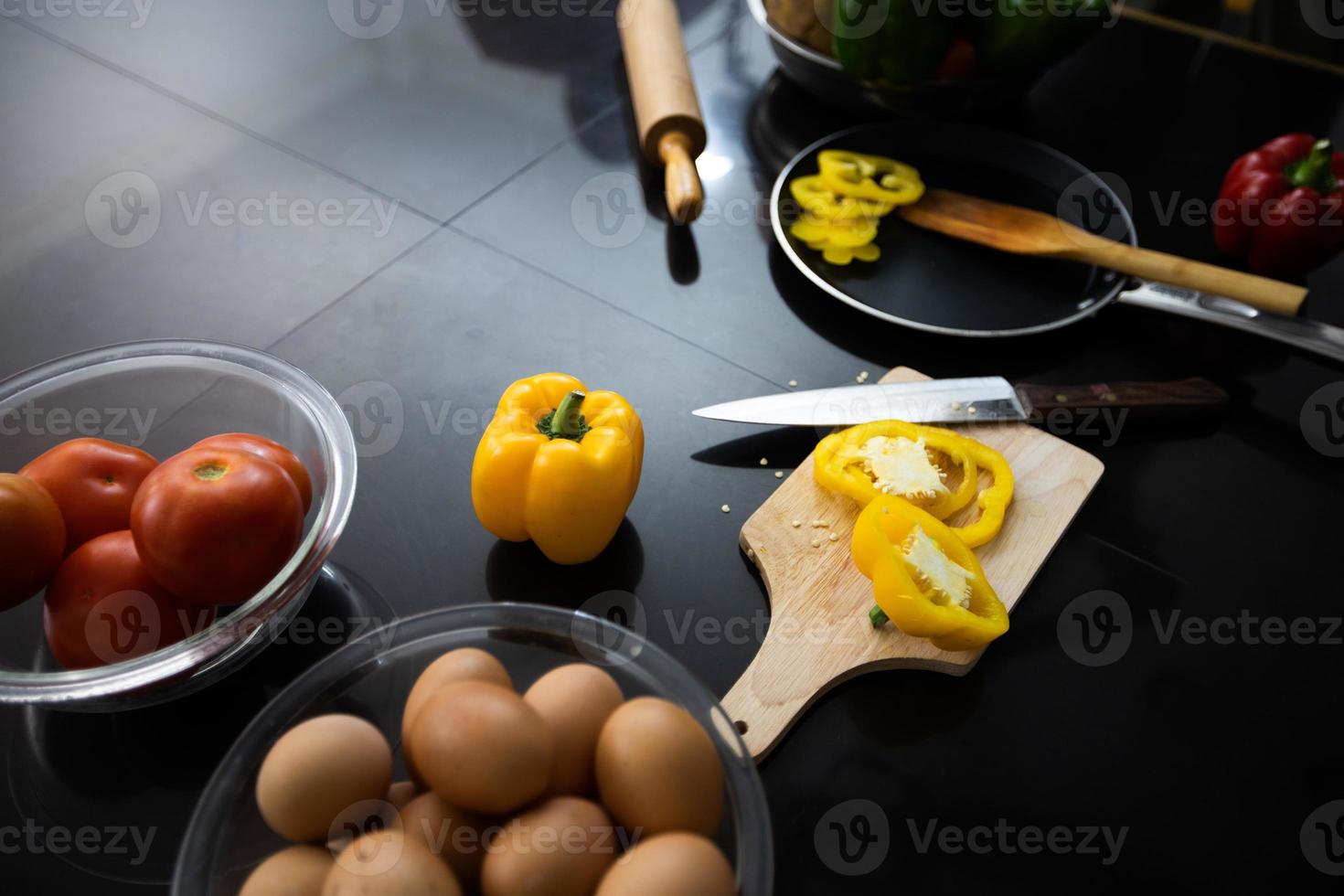 Food and fresh vegetables and salad bowls on kitchen table on top view .Healthy eating concept photo