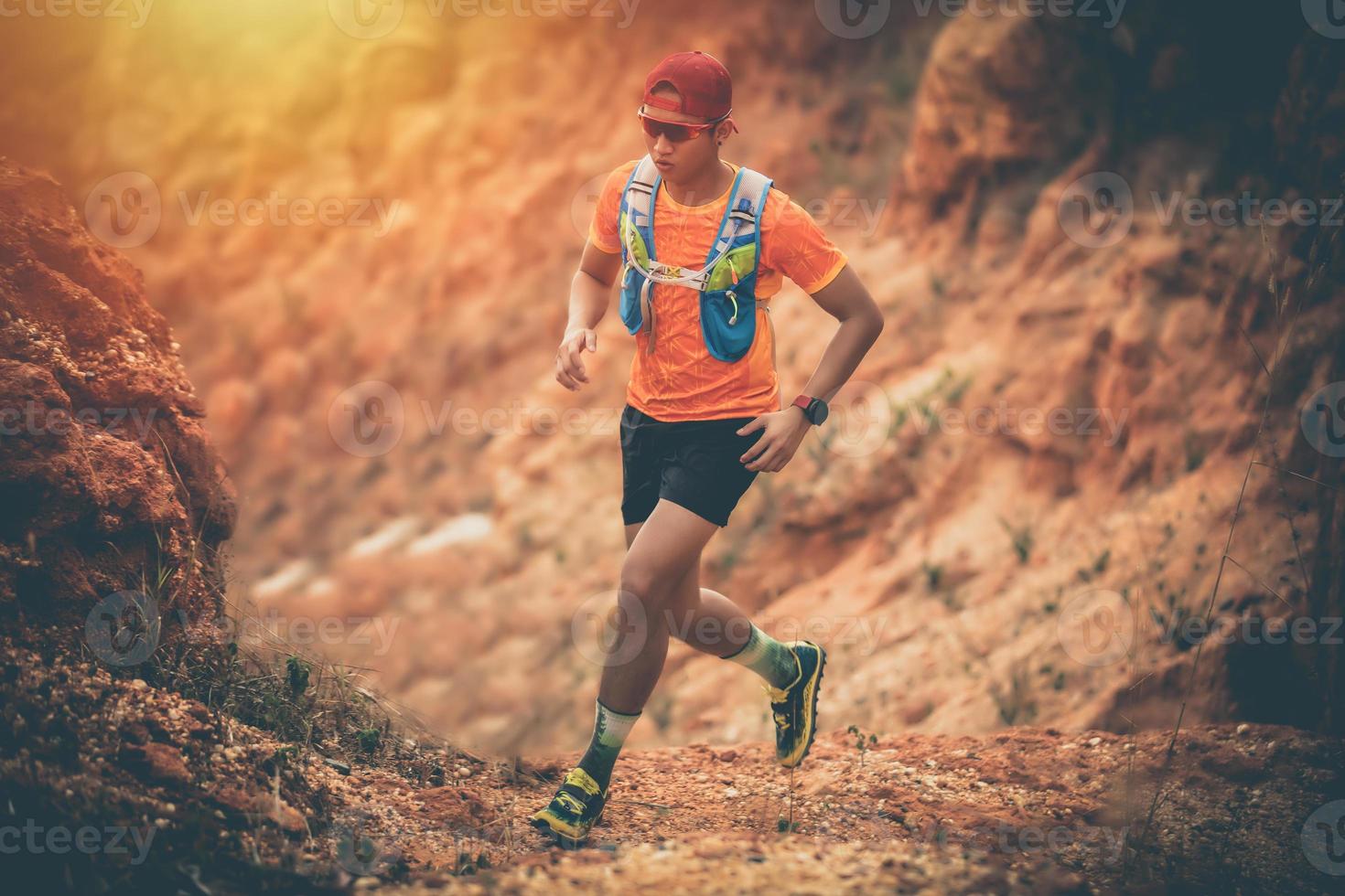 A man Runner of Trail and athlete's feet wearing sports shoes for trail running in the mountain photo