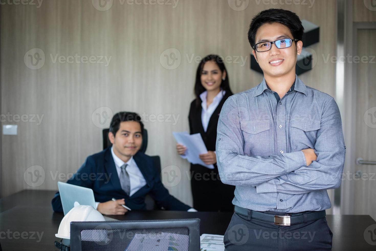 Asian business man and group using notebook for meeting and business men smiling happy for working photo