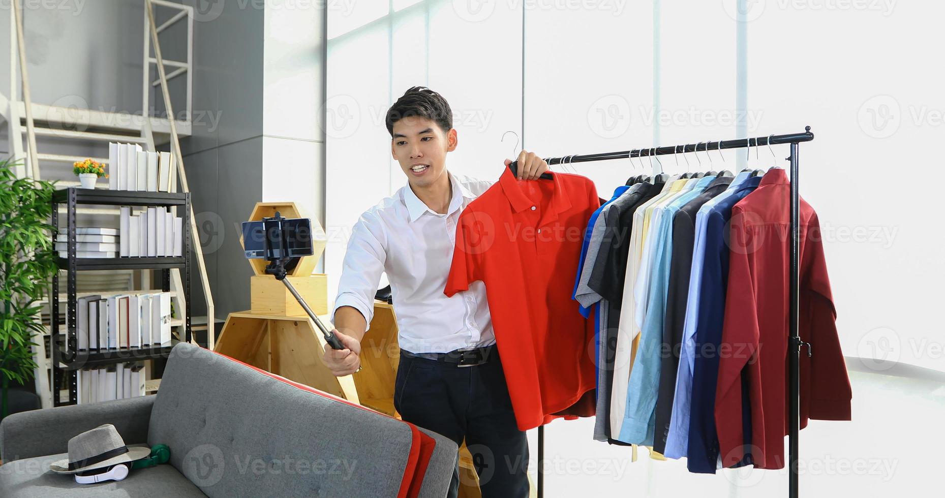 Asian man  blogger broadcasting a video for selling product online .Shopping online concept photo