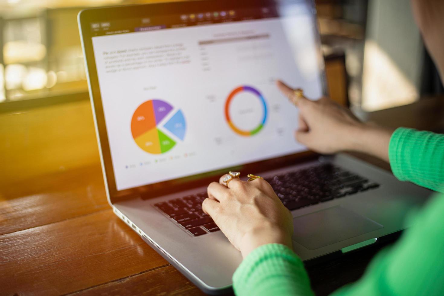 Asian businesswomen using notebook for analysis documents and graph financial diagram working photo