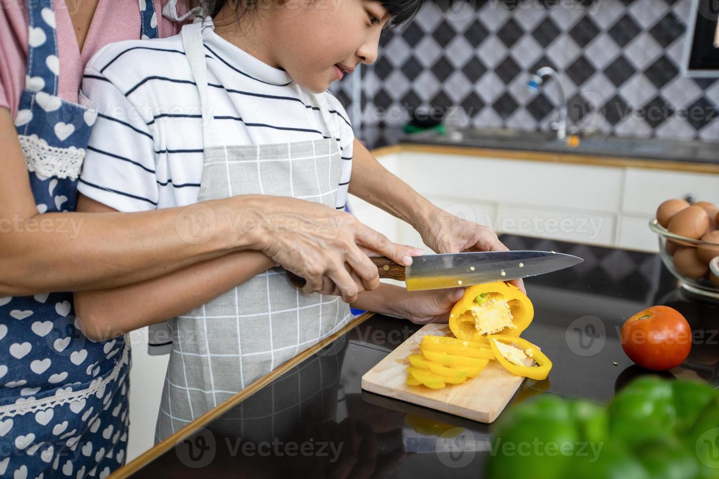 Happy Family have Dad, Mom and their little daughter Cooking Together in the Kitchen photo