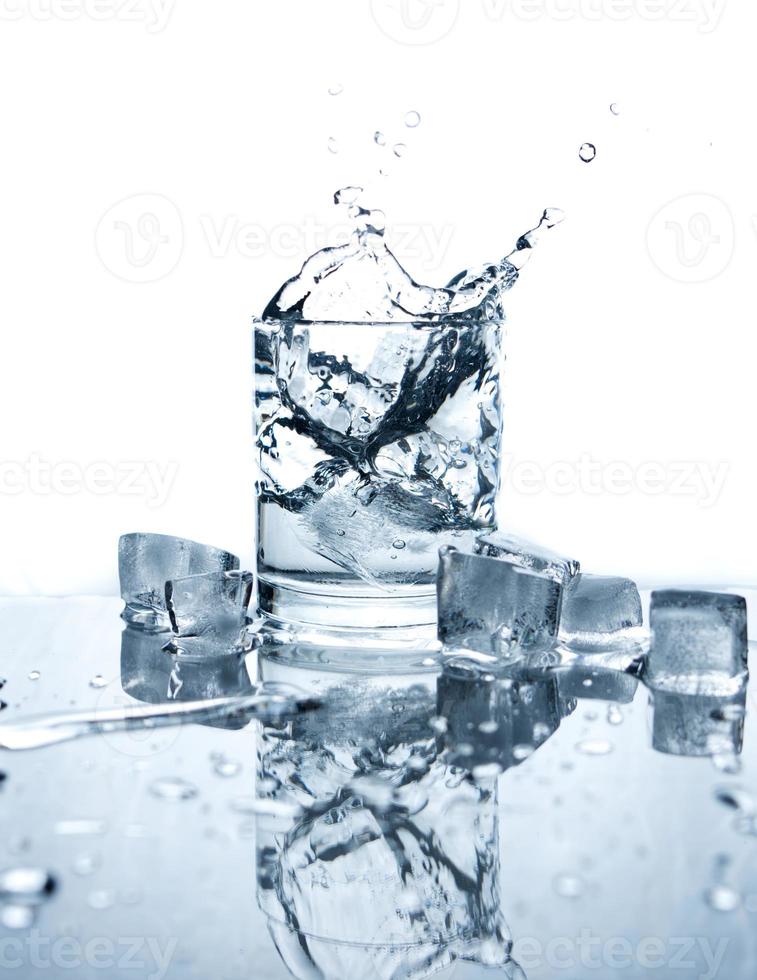 Drinking water splashed with ice in glass photo
