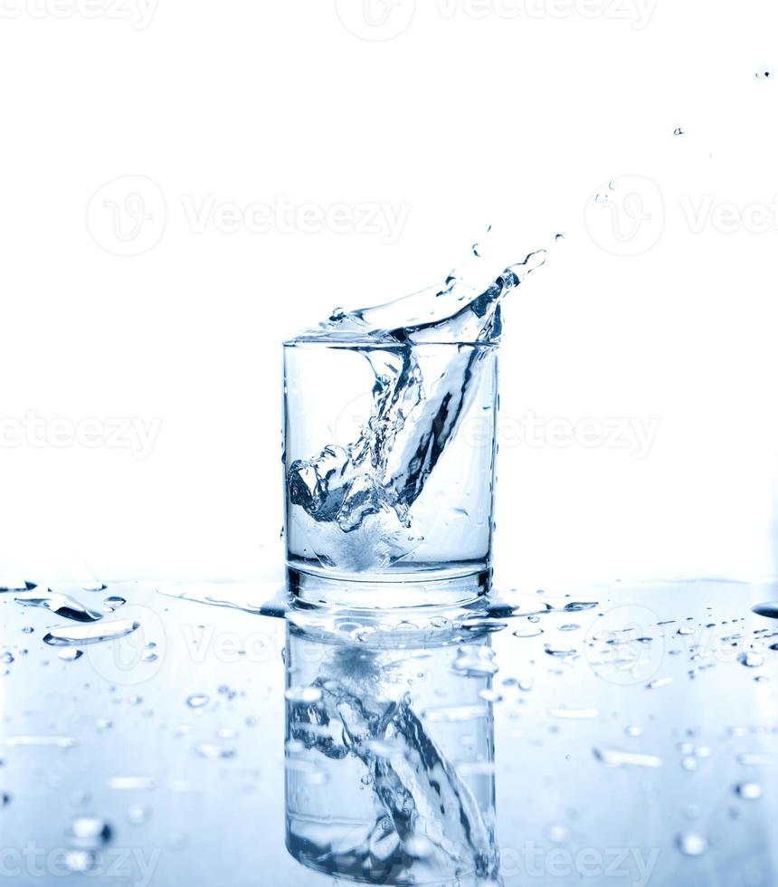 Drinking water splashed with ice in glass photo