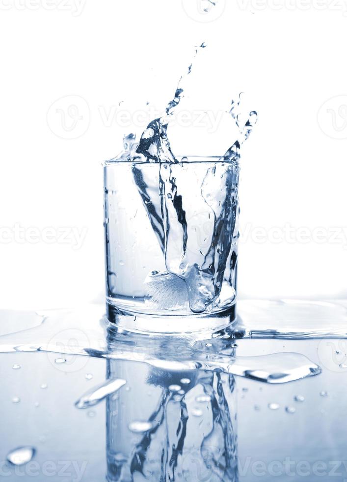 Drinking water splashed with ice in glass photo