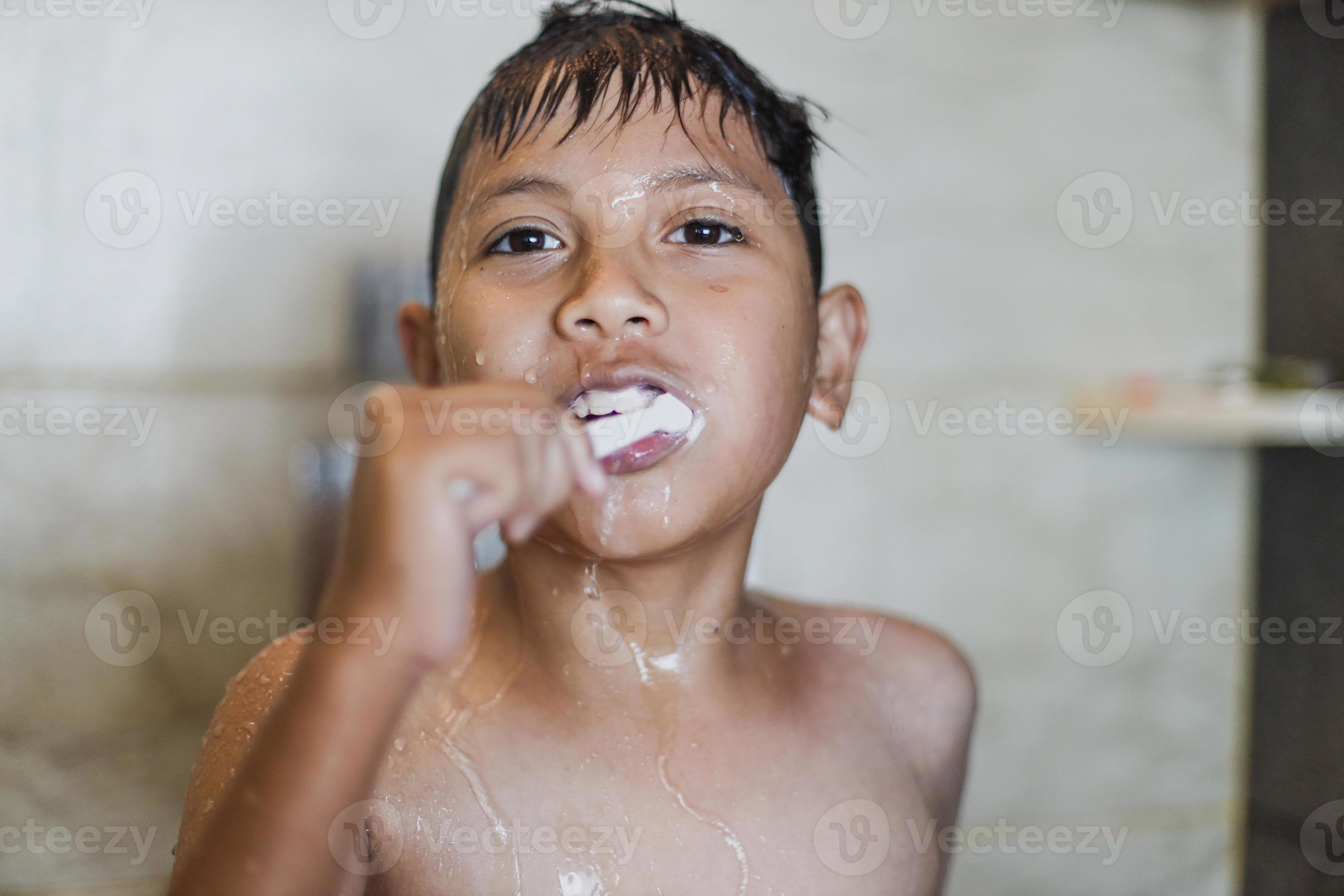 Asian boy brushing teeth with foam coming out of his mouth 6638797