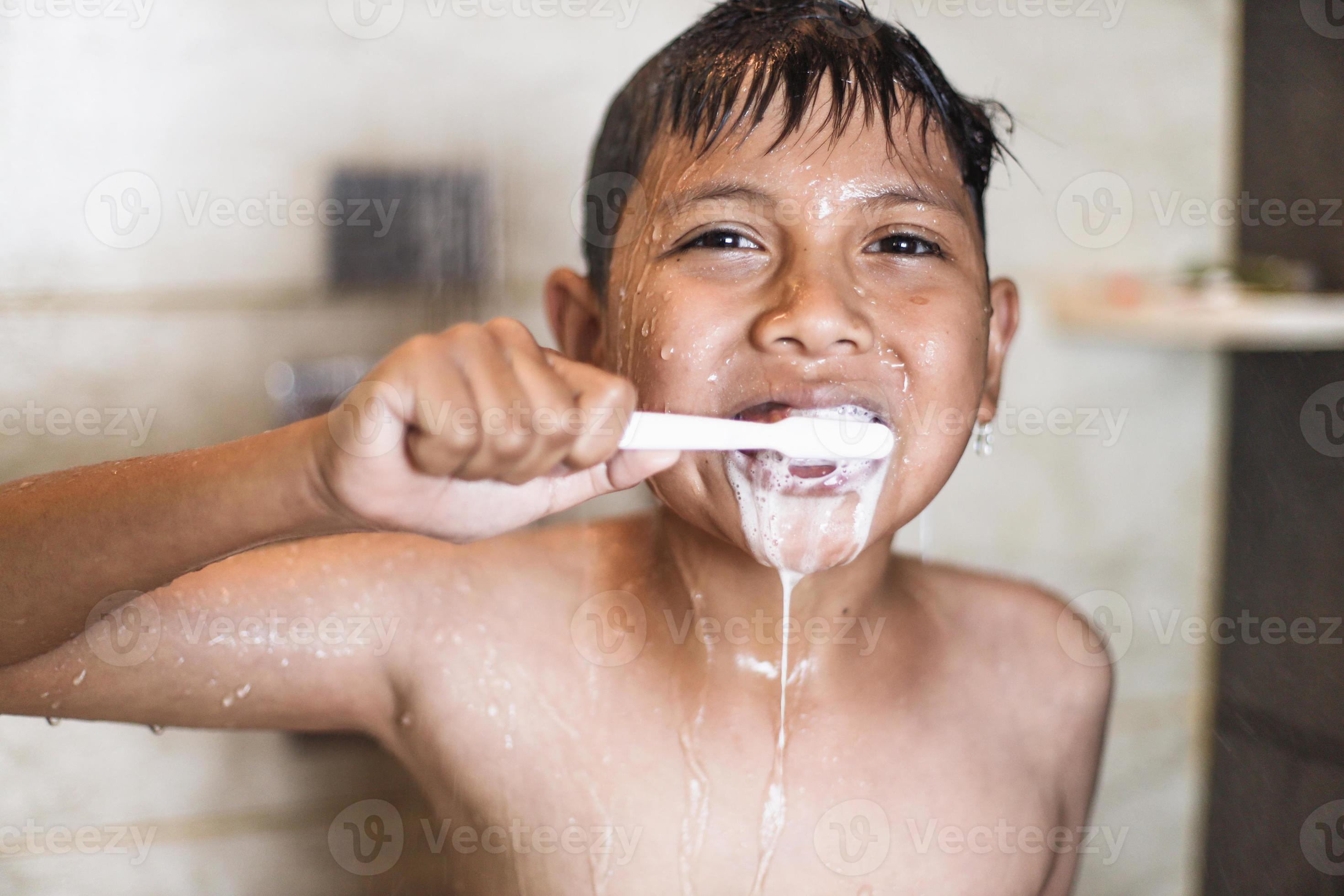 Asian boy brushing teeth with foam coming out of his mouth 6638804