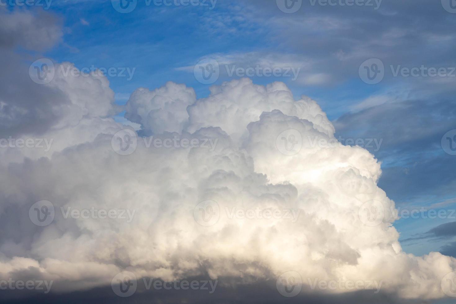 White clouds on the blue sky. Cloud forming a thick uniform gray layer. photo