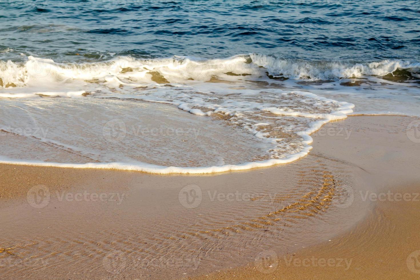 Beautiful white ocean waves on the empty beach. photo