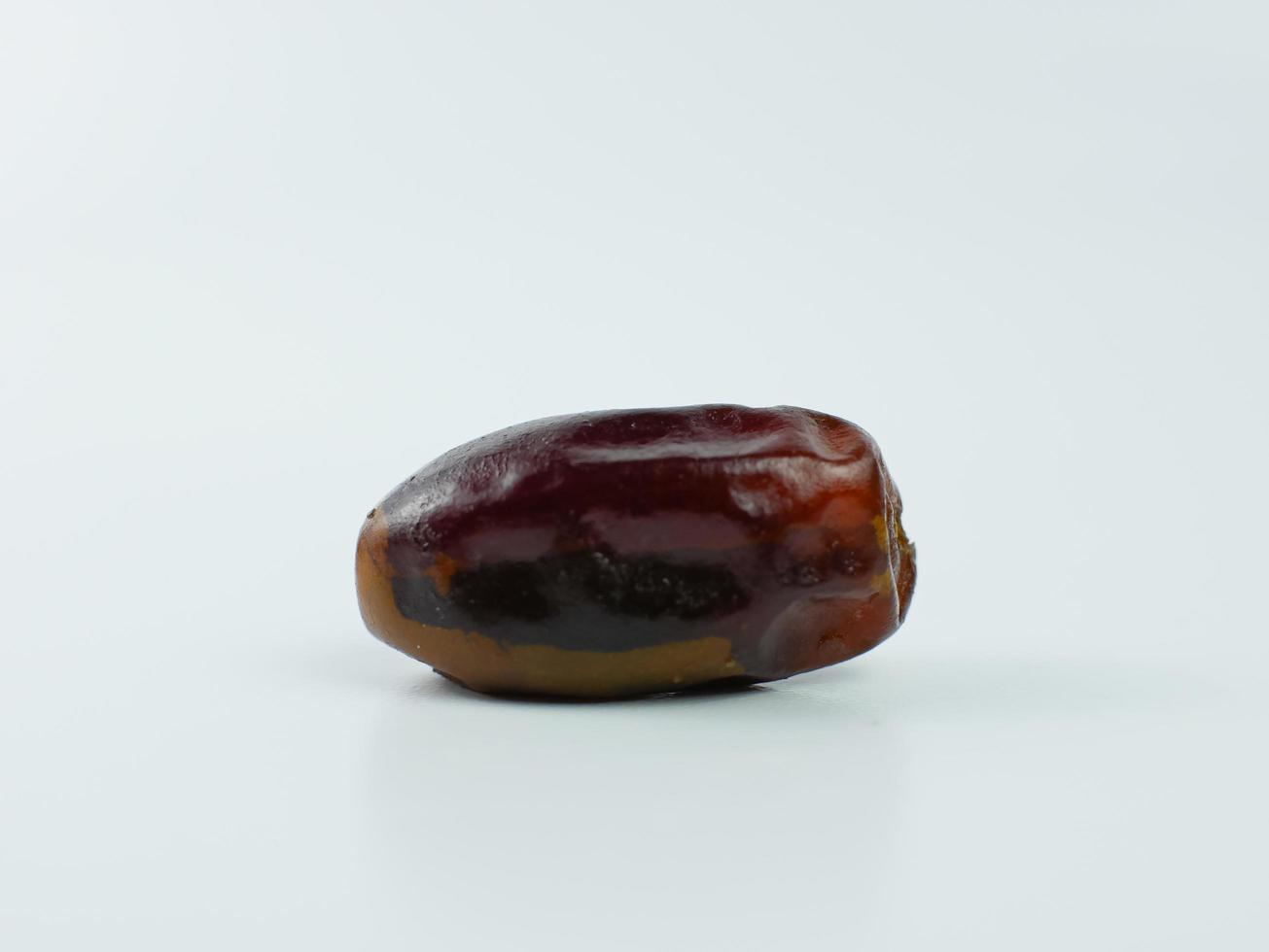 one date isolated on a white background. healthy fruit ramadan concept photo