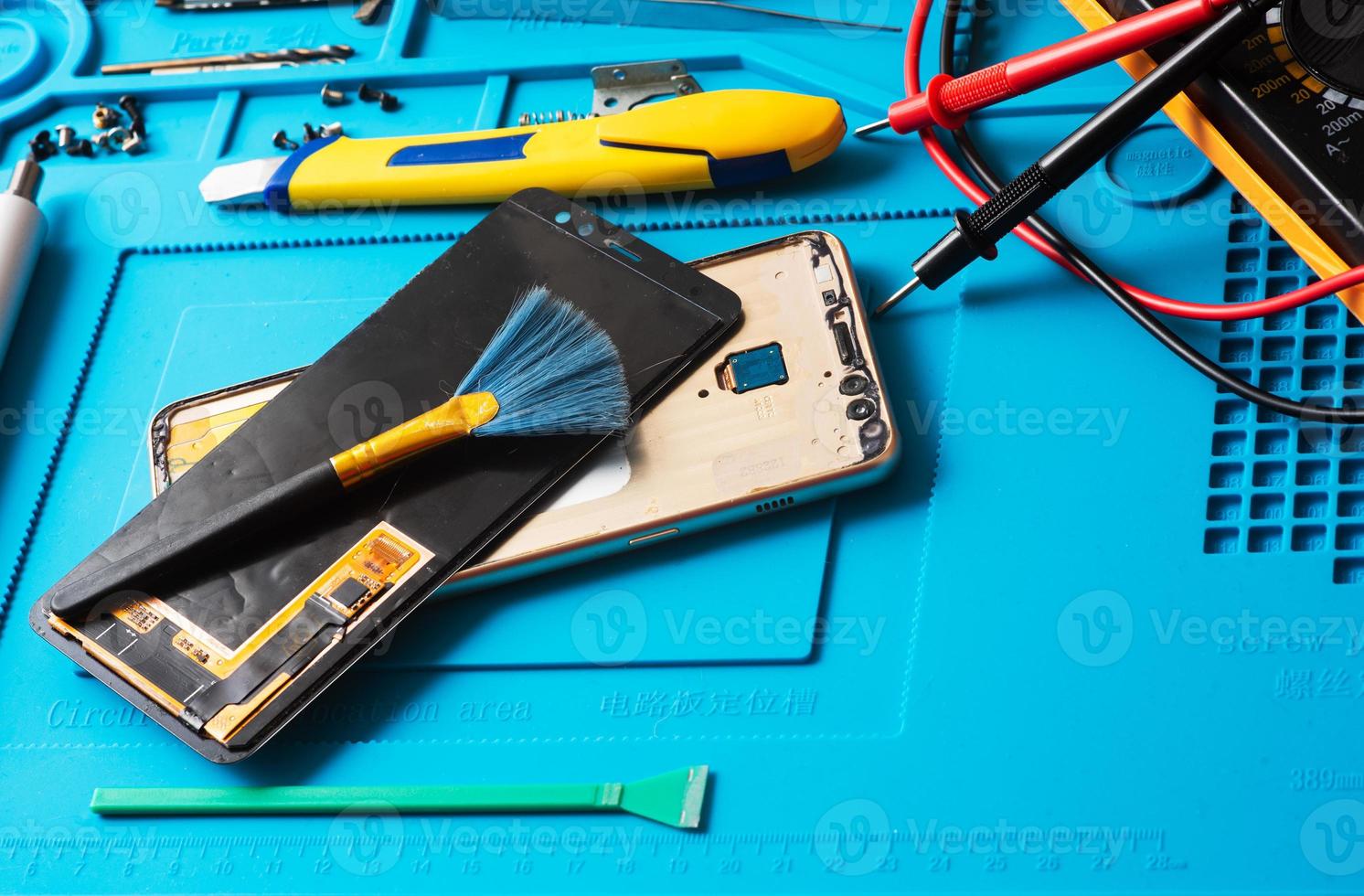 Flat lay image of dismantling the broken smart phone for preparing to repair or replace some components, Top view photo