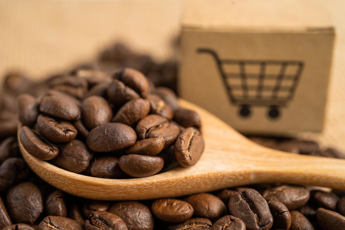 Box with shopping cart logo symbol on coffee beans, Import Export Shopping online or eCommerce delivery service store product shipping, trade, supplier concept. photo