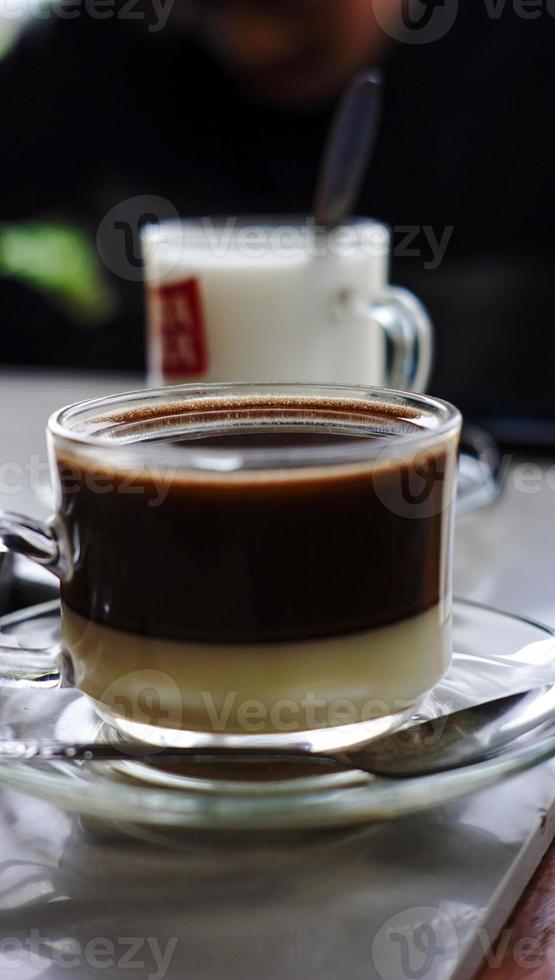 cup of milk coffee with spoon photo