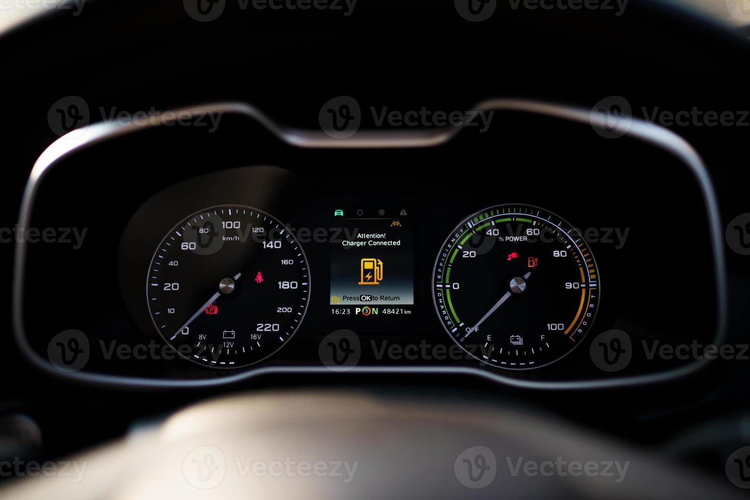 Dashboard behind the steering wheel in electric vehicle - EV car while charging. photo