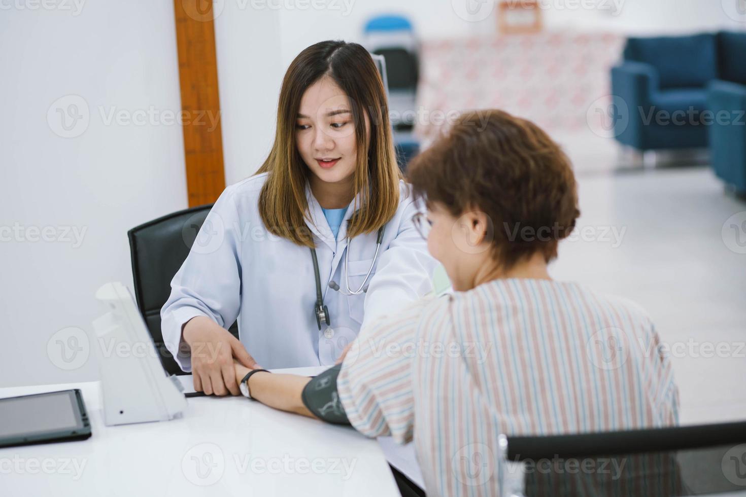 close up doctor checking senior patient blood pressure. Health care. photo