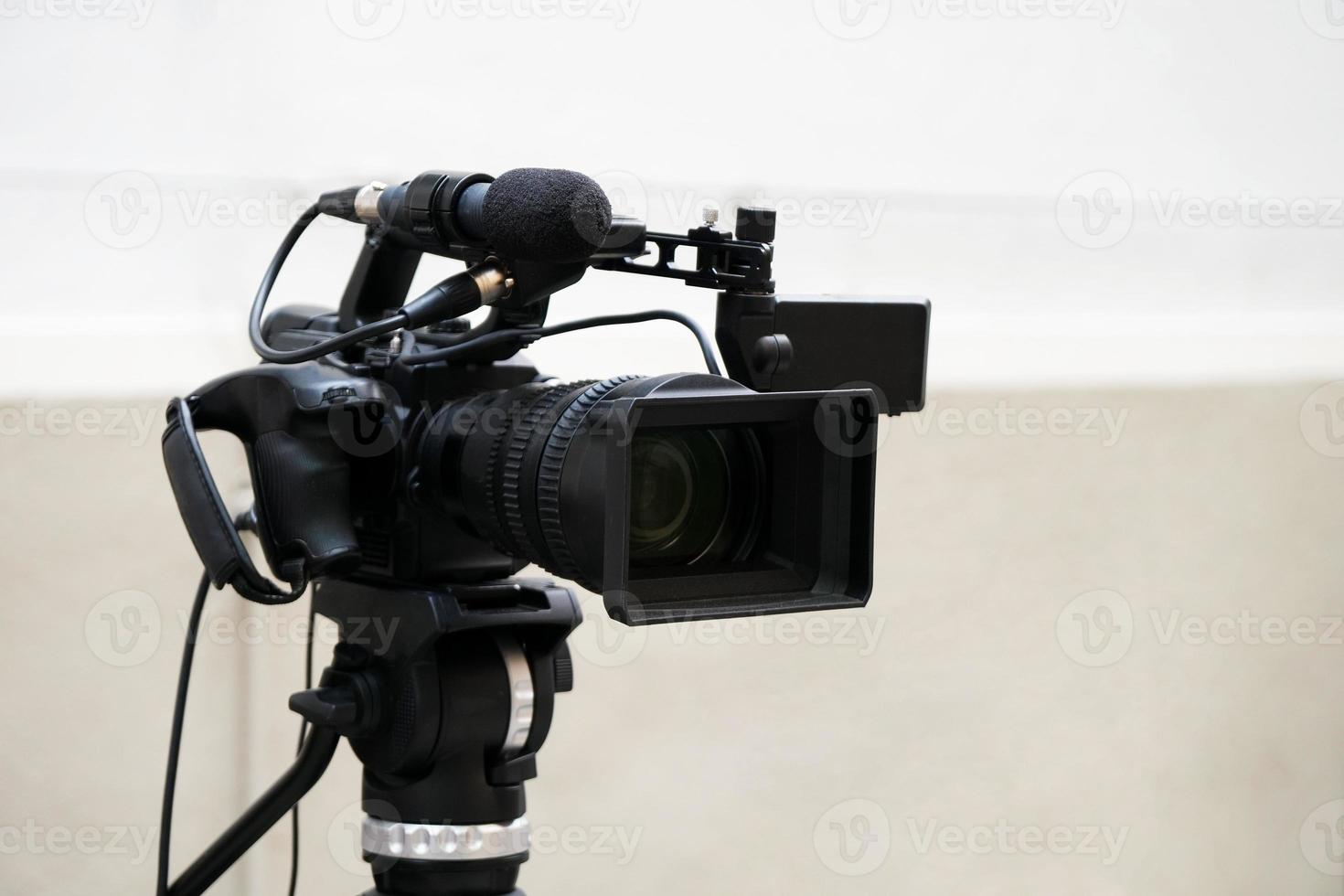 digital video or movie camera on tripod photo