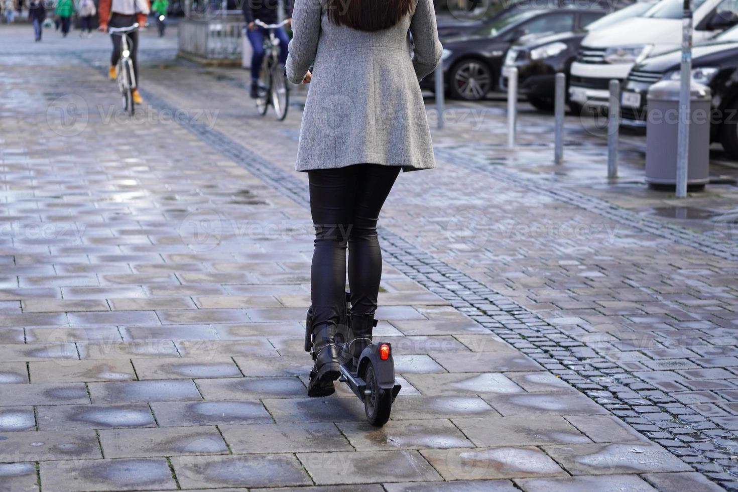 electric scooter or e-scooter on busy sidewalk in city photo