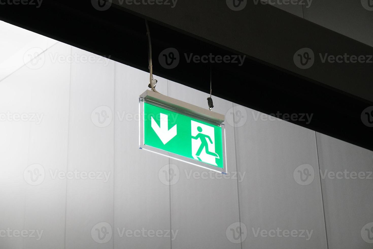 emergency exit or fire escape sign with running man symbol and arrow photo