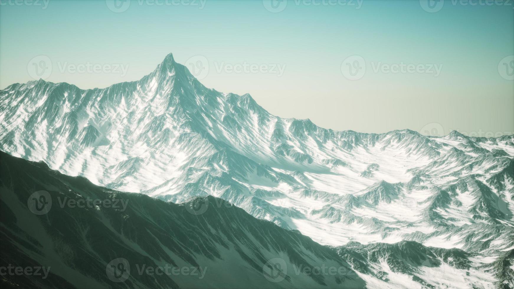 panoramic mountain view of snow capped peaks and glaciers photo