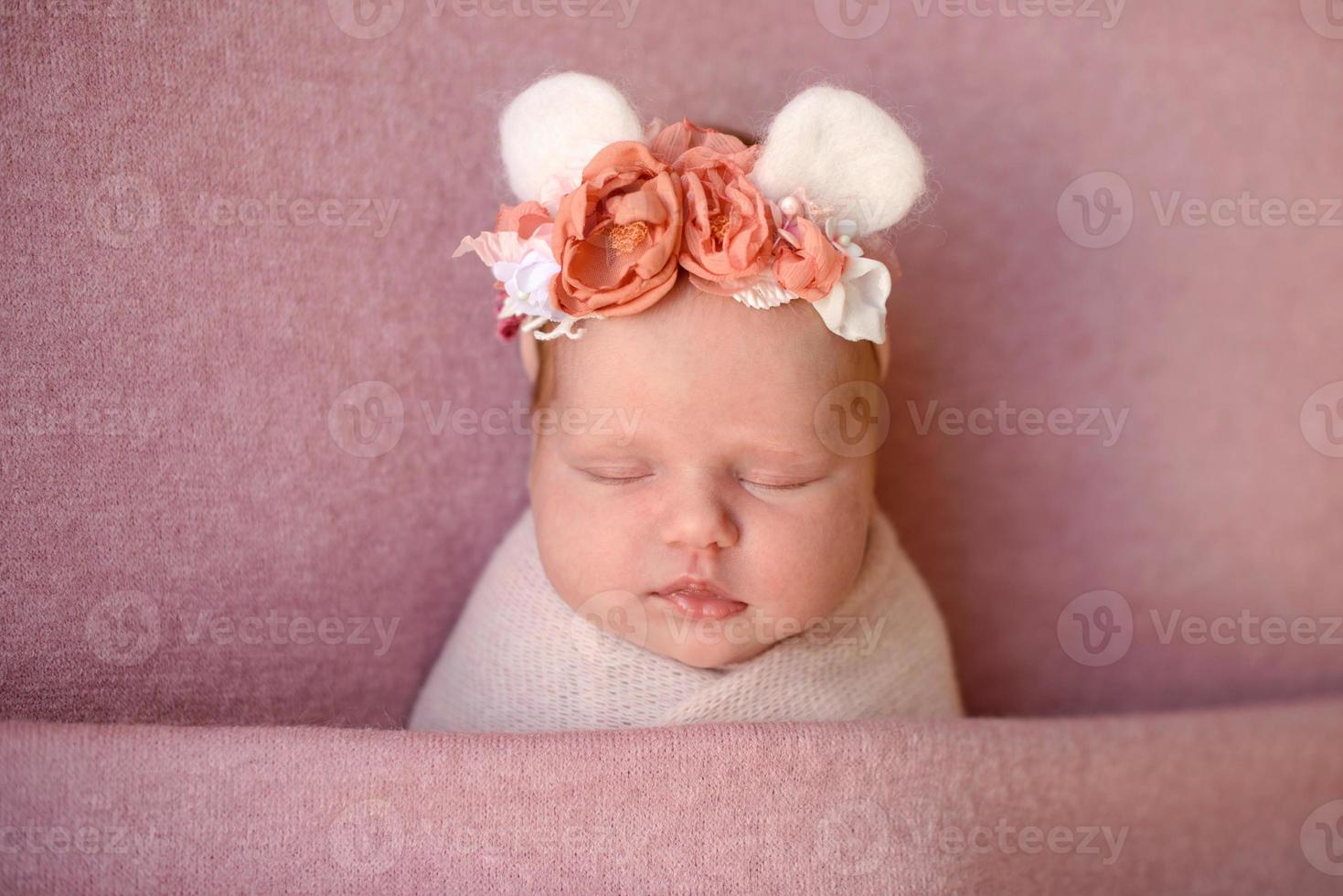 Close-up beautiful sleeping baby girl. Newborn baby girl, asleep on a blanket photo