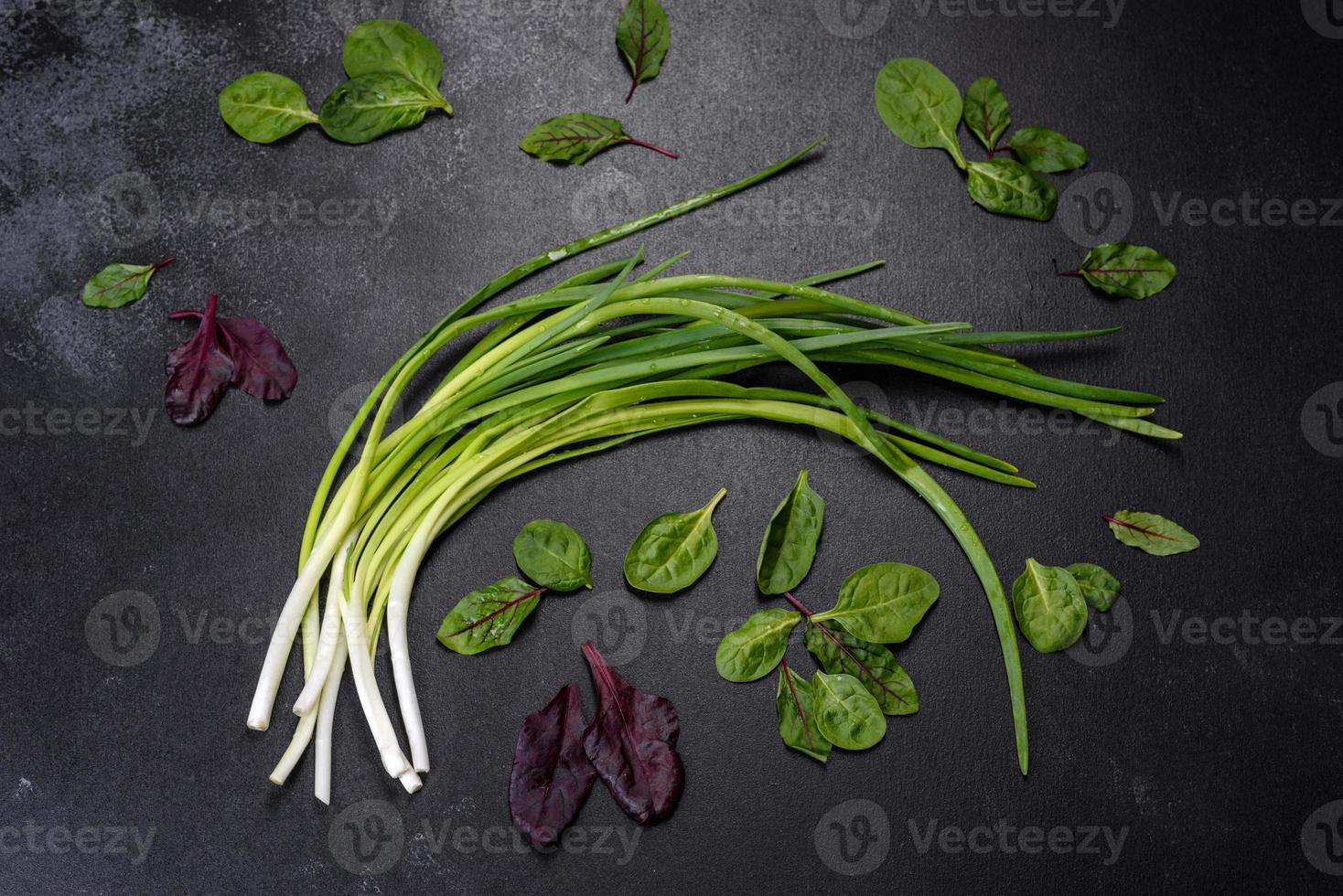 Green onion or scallion on wooden board, fresh spring chives photo