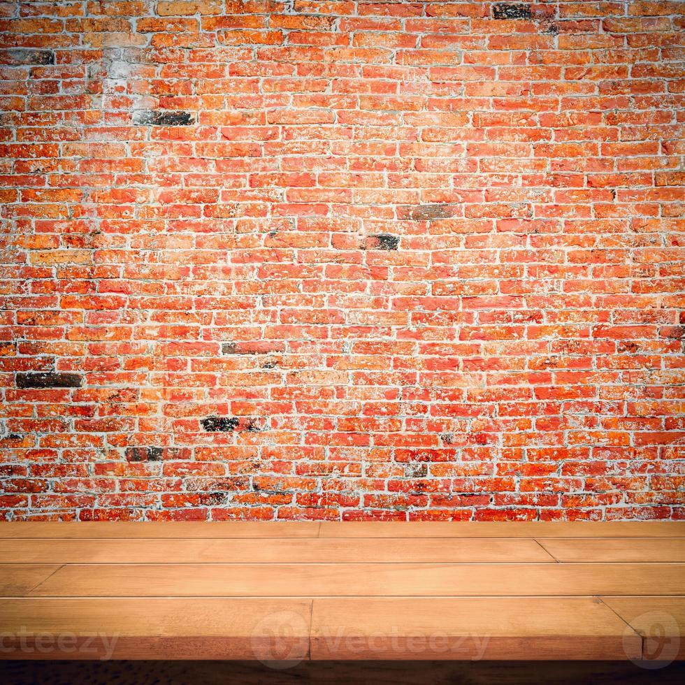Empty wooden table with red brick wall background. photo