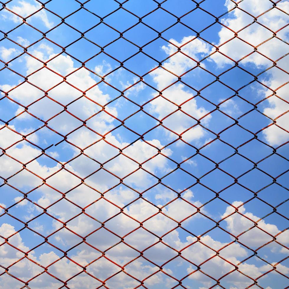 Metallic net on blue sky background photo