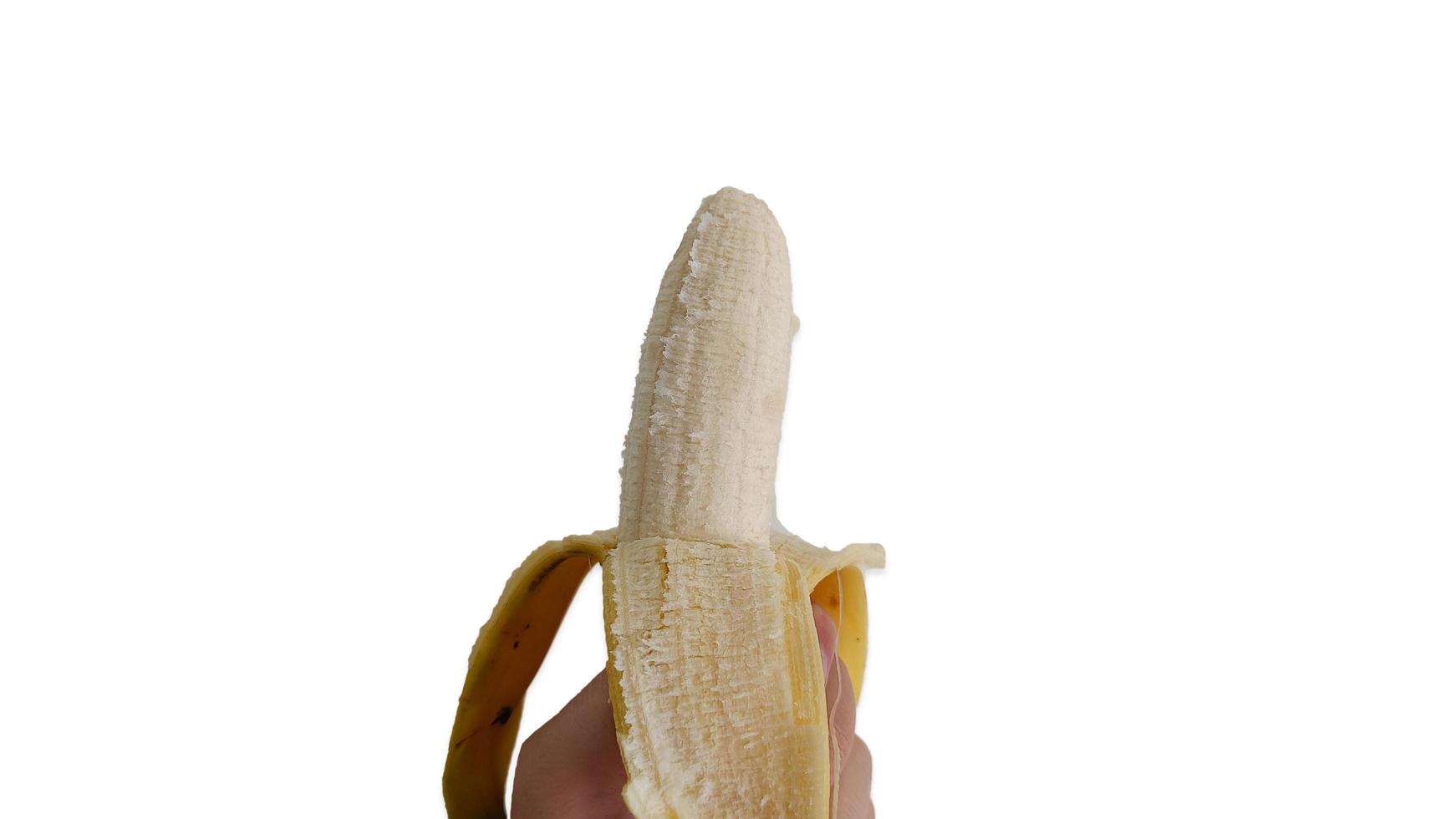 Hand holding a peel banana photo